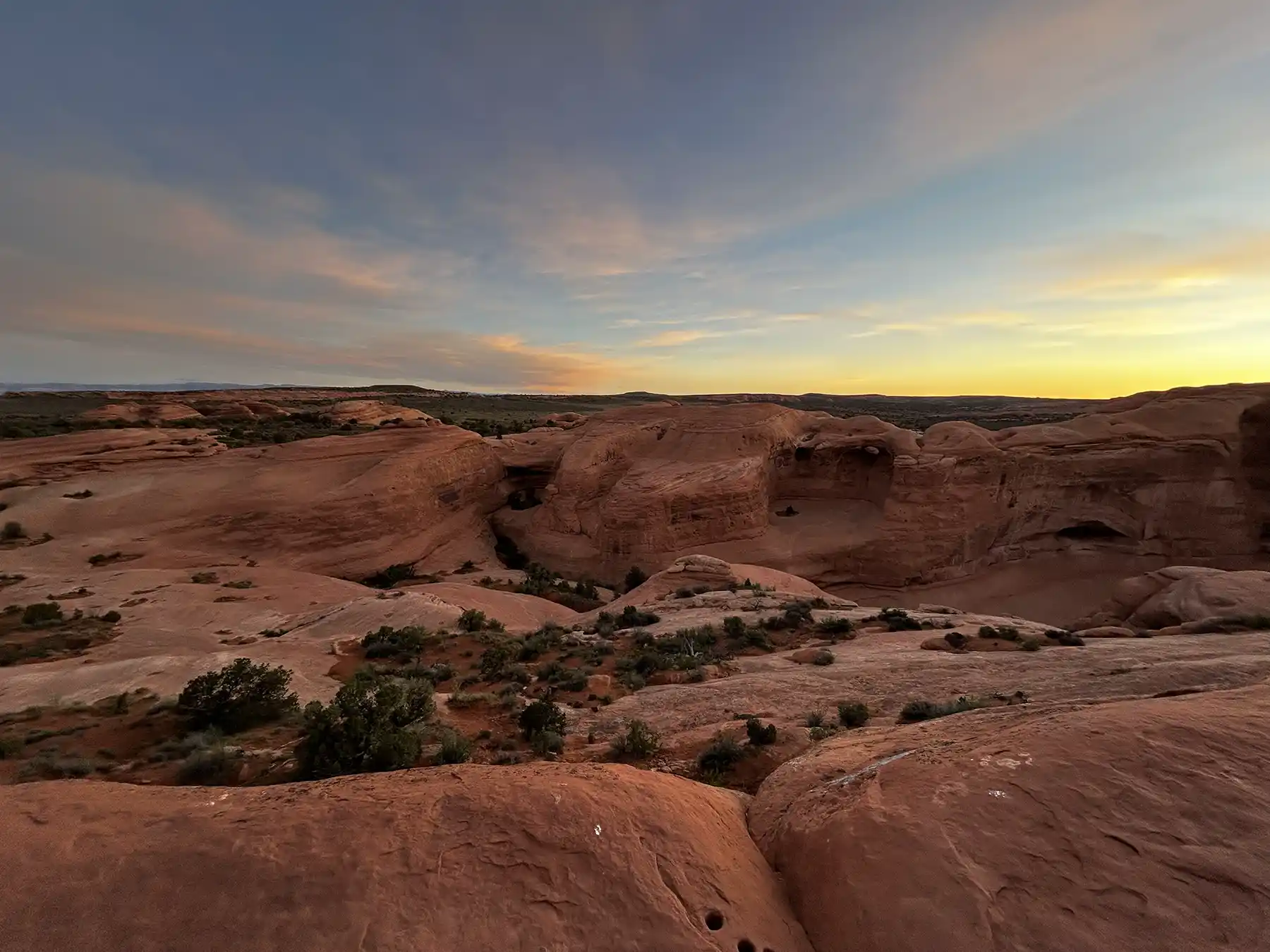 Hikers exploring red rock formations in Arches National Park